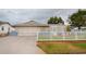 Charming single-story home with a white picket fence and landscaped yard at 6321 Staunton Dr, Holiday, FL 34690