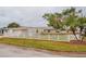 House exterior showcasing a large yard with a white picket fence at 6321 Staunton Dr, Holiday, FL 34690
