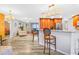 Kitchen with barstool seating, stainless steel appliances, and open access to living areas at 6321 Staunton Dr, Holiday, FL 34690