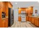 Modern kitchen with stainless steel appliances and wood cabinets at 6321 Staunton Dr, Holiday, FL 34690
