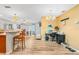 Open-concept living room featuring wood floors, a breakfast bar, and a defined office space at 6321 Staunton Dr, Holiday, FL 34690