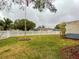 Side yard with white fence and landscaping at 6321 Staunton Dr, Holiday, FL 34690