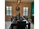 Dining room with a modern table, shuttered windows, and an accent wall at 6445 Tideline Dr, Apollo Beach, FL 33572