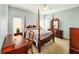 Spacious bedroom with a post bed, dresser, and desk at 7115 W Creek Dr, Tampa, FL 33615