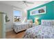 Twin bedroom with nautical bedding, teal accent wall, and window seat at 752 N Shore Dr, Anna Maria, FL 34216