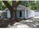 Charming bungalow with gray siding, mature tree, and a well-manicured yard at 8010 N 11Th St, Tampa, FL 33604