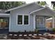 Renovated craftsman home with gray siding, front porch, and landscaping at 8010 N 11Th St, Tampa, FL 33604