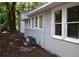 Side view showcasing gray siding and large windows at 8010 N 11Th St, Tampa, FL 33604