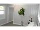 Living room with gray walls, wood-look floors, and a large plant at 8010 N 11Th St, Tampa, FL 33604