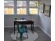 Bright home office with a wooden desk and teal chairs at 8010 N 11Th St, Tampa, FL 33604