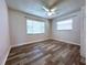 Bedroom with wood-look flooring, closet, and windows at 8153 22Nd N Ave, St Petersburg, FL 33710