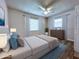 Cozy bedroom with hardwood floors, bright windows with a ceiling fan, and tasteful decor at 8153 22Nd N Ave, St Petersburg, FL 33710