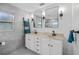 Modern bathroom boasts double vanity, grey tile and updated fixtures at 1558 13Th S St, St Petersburg, FL 33705