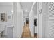 Long hallway with light walls and wood floors connects rooms at 1558 13Th S St, St Petersburg, FL 33705
