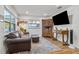 Living room features a brown leather couch and decorative wood cabinet at 1558 13Th S St, St Petersburg, FL 33705