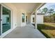 Covered back patio with concrete flooring and grassy yard at 16117 Medrick Rd, Brooksville, FL 34614