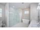 Spacious primary bathroom with glass shower, freestanding tub, tile floor at 16117 Medrick Rd, Brooksville, FL 34614