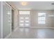 Bright entryway with double front doors and a sliding barn door at 16117 Medrick Rd, Brooksville, FL 34614