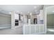 Modern white kitchen with island, stainless steel appliances, and recessed lighting at 16117 Medrick Rd, Brooksville, FL 34614