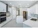 White kitchen featuring an island with quartz countertops, and stainless steel appliances at 16117 Medrick Rd, Brooksville, FL 34614