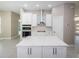 Bright kitchen with white cabinets, quartz countertops, and island with cooktop at 16117 Medrick Rd, Brooksville, FL 34614