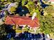 Aerial view of condo building with red tile roof and pond at 1800 Mariner Dr # 3, Tarpon Springs, FL 34689