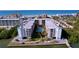 Aerial view of condo building, pool, and surrounding area at 19531 Gulf Blvd # 611, Indian Shores, FL 33785