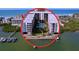 Aerial view of waterfront condo building with pool and boat slips at 19531 Gulf Blvd # 611, Indian Shores, FL 33785