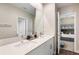 Bathroom with double vanity and a view into a bedroom at 21361 Snowy Orchid Ter, Land O Lakes, FL 34637