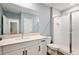 Modern bathroom with white vanity and shower at 21361 Snowy Orchid Ter, Land O Lakes, FL 34637