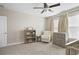 Charming Bedroom features a rocker, dresser, and shelving at 21361 Snowy Orchid Ter, Land O Lakes, FL 34637