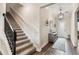 Elegant entryway with staircase, wood flooring, and decorative accents at 21361 Snowy Orchid Ter, Land O Lakes, FL 34637