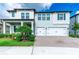 Beautiful two-story home featuring a three-car garage and charming landscaping at 21361 Snowy Orchid Ter, Land O Lakes, FL 34637