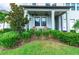 Inviting front porch with two Adirondack chairs and lush landscaping at 21361 Snowy Orchid Ter, Land O Lakes, FL 34637