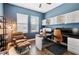 Spacious home office with two desks, built-in cabinets, and comfortable seating at 21361 Snowy Orchid Ter, Land O Lakes, FL 34637