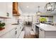 Modern kitchen with white cabinets, quartz countertops and breakfast nook at 21361 Snowy Orchid Ter, Land O Lakes, FL 34637