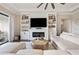 Spacious living room with sectional sofa and built-in entertainment center at 21361 Snowy Orchid Ter, Land O Lakes, FL 34637