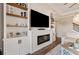 Living room features built-in shelving, fireplace, and large TV at 21361 Snowy Orchid Ter, Land O Lakes, FL 34637