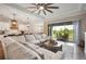 Open living area with sectional sofa, sliding doors to patio, and views of backyard at 21361 Snowy Orchid Ter, Land O Lakes, FL 34637