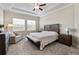 Main bedroom with king bed and seating area at 21361 Snowy Orchid Ter, Land O Lakes, FL 34637