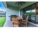 Covered patio with table and chairs, great for outdoor dining at 21361 Snowy Orchid Ter, Land O Lakes, FL 34637
