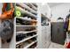 Spacious walk-in closet with ample shelving and a safe at 21361 Snowy Orchid Ter, Land O Lakes, FL 34637