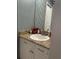 Well-appointed bathroom with a vanity, sink, and stylish striped wallpaper at 2280 Bancroft S Cir # A, Palm Harbor, FL 34683