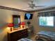 Spacious bedroom with two beds, a dresser, and a wall-mounted TV at 2280 Bancroft S Cir # A, Palm Harbor, FL 34683