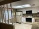 Bright, eat-in kitchen with white cabinets, granite countertops, and appliances at 2280 Bancroft S Cir # A, Palm Harbor, FL 34683