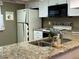 Kitchen boasts granite countertops, white cabinetry, and essential appliances at 2280 Bancroft S Cir # A, Palm Harbor, FL 34683