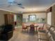 Inviting living area with ample seating, a dining table, and a view of the kitchen at 2280 Bancroft S Cir # A, Palm Harbor, FL 34683