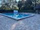 Inviting community pool with ample space for swimming and lounging, surrounded by brick pavers at 2280 Bancroft S Cir # A, Palm Harbor, FL 34683