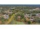 An aerial shot of houses in a community near a pond and surrounded by trees at 2376 Meadow Lark Rd, Spring Hill, FL 34608