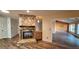 Living room featuring a stone fireplace and wood-look floors at 3030 Bolt Dr, Palm Harbor, FL 34685